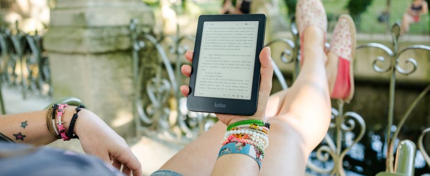 person holding person holding kobo e reader